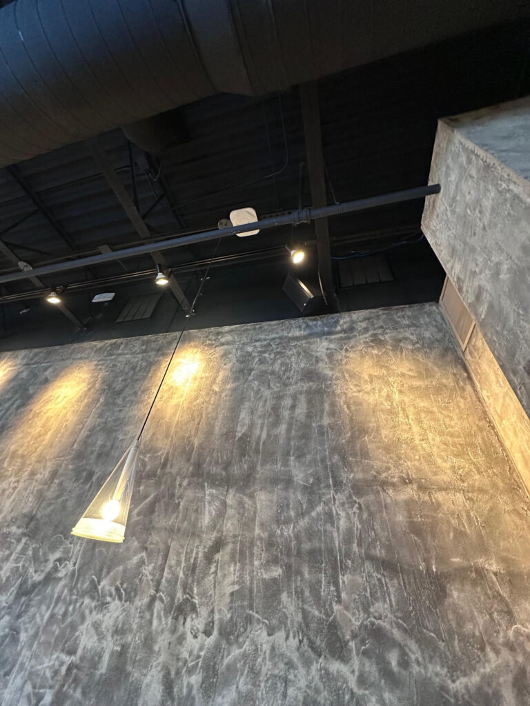 Painted spiral ductwork along a restaurant feature wall – Alltech HVAC